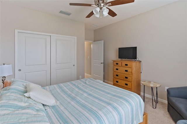 carpeted bedroom featuring ceiling fan and a closet