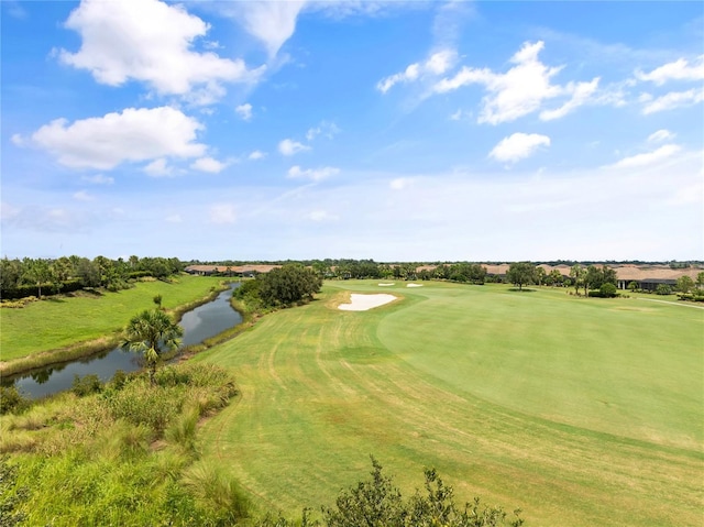 bird's eye view featuring golf course view and a water view