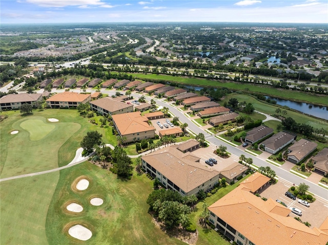 drone / aerial view featuring a residential view, a water view, and golf course view