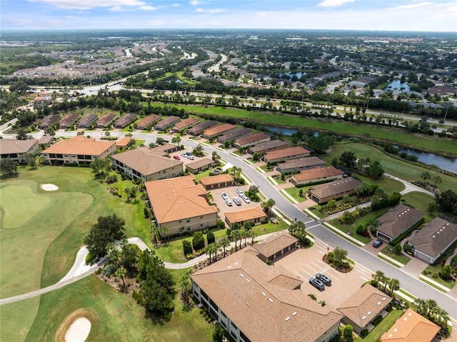 drone / aerial view with a water view, a residential view, and golf course view