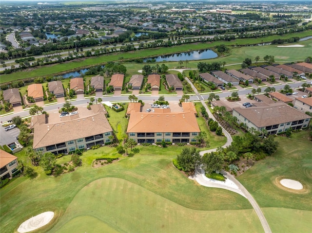 aerial view featuring golf course view, a water view, and a residential view