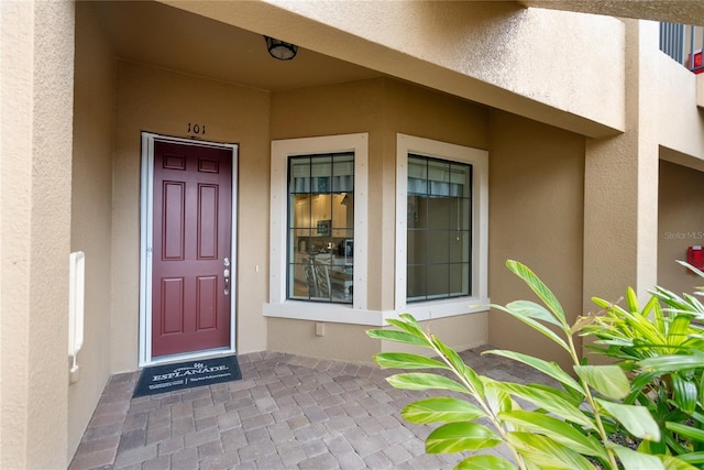 property entrance featuring stucco siding