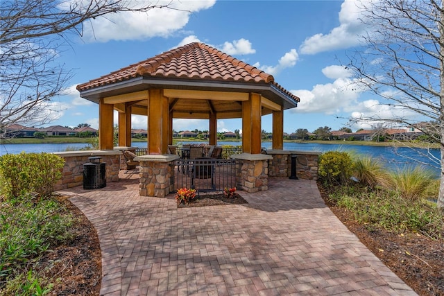 view of patio with a water view and a gazebo