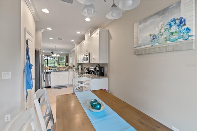 dining area featuring crown molding, light tile patterned flooring, and recessed lighting