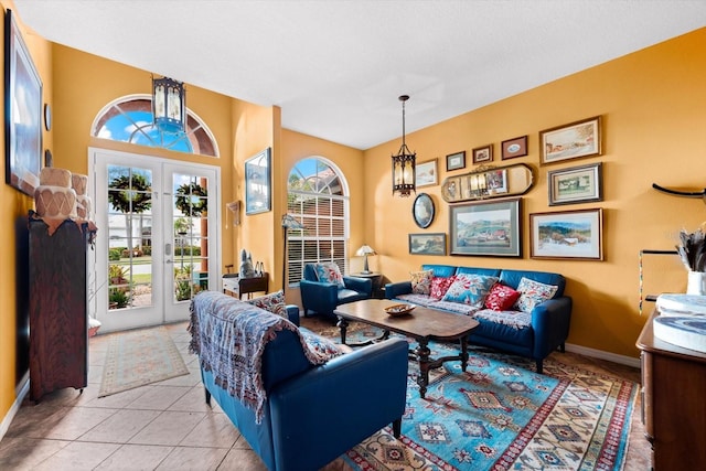 interior space featuring light tile patterned floors, an inviting chandelier, french doors, and a healthy amount of sunlight