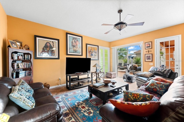 living room with ceiling fan and tile patterned flooring