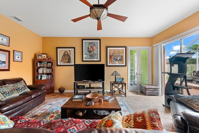 living room featuring french doors, light tile patterned floors, and ceiling fan