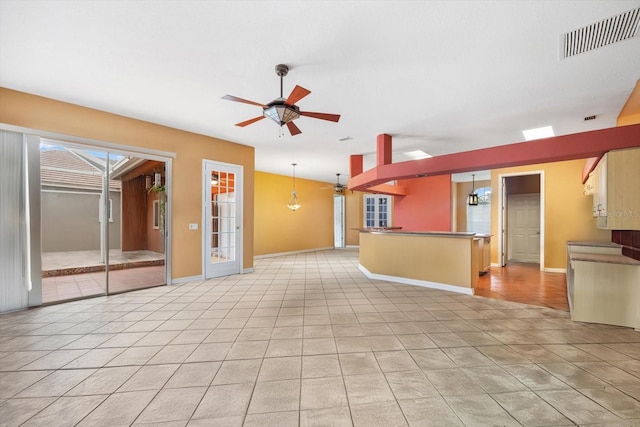 interior space with ceiling fan and light tile patterned flooring