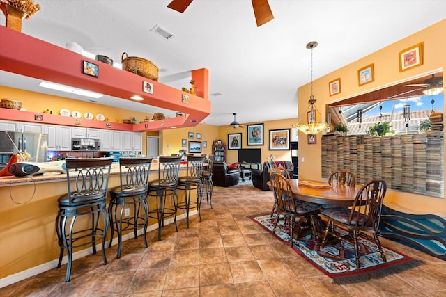 dining space with tile patterned flooring and ceiling fan with notable chandelier