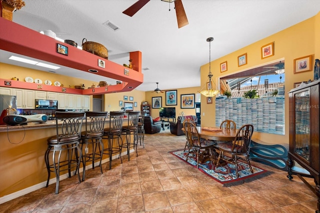 dining room featuring light tile patterned floors and ceiling fan