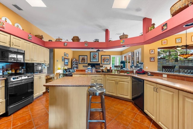 kitchen with light tile patterned floors, a kitchen island, a breakfast bar area, and black appliances