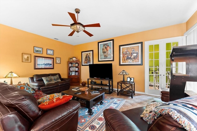 tiled living room with ceiling fan and french doors