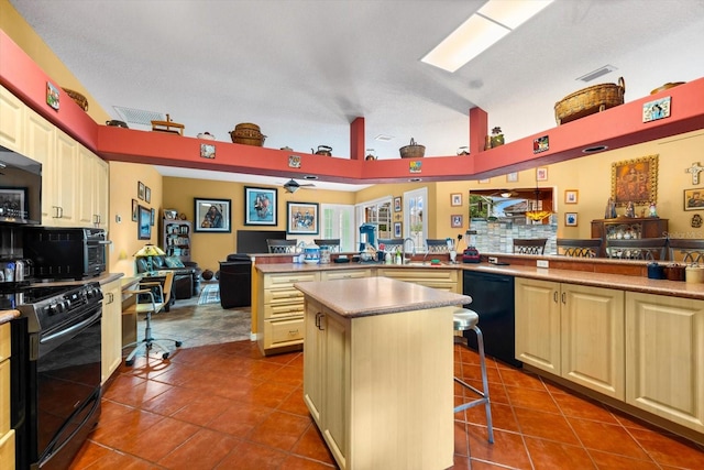 kitchen featuring a breakfast bar, a center island, black appliances, tile patterned flooring, and kitchen peninsula