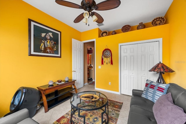 living room featuring ceiling fan and light tile patterned floors