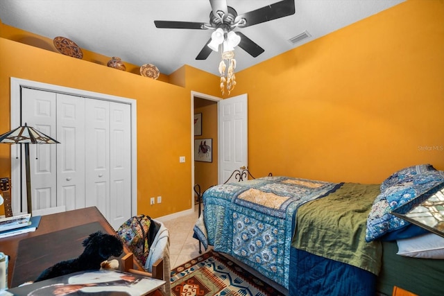 bedroom featuring tile patterned flooring, ceiling fan, and a closet