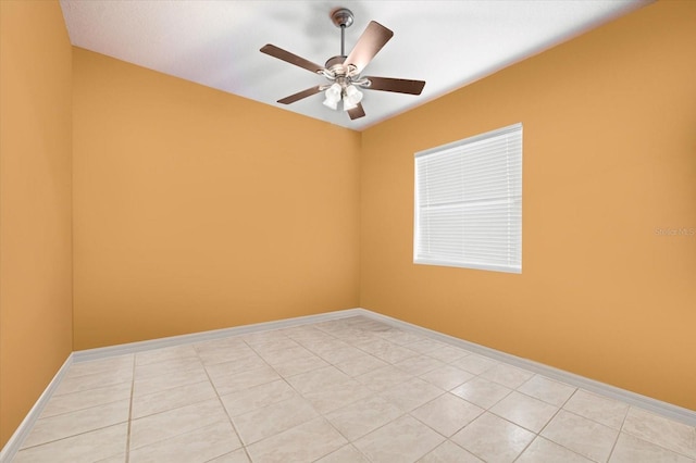 tiled empty room featuring ceiling fan