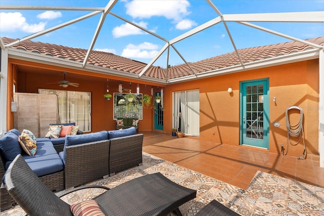 view of patio featuring outdoor lounge area, ceiling fan, and a lanai