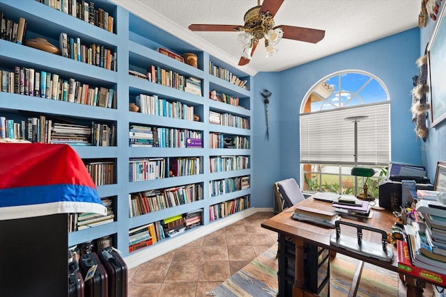 tiled office space featuring ceiling fan, built in features, and a textured ceiling