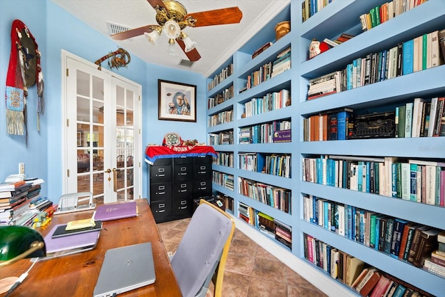 tiled office space with built in shelves, a textured ceiling, and ceiling fan