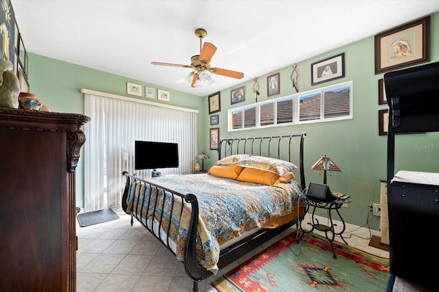 bedroom with ceiling fan and light tile patterned floors