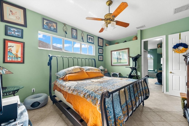 tiled bedroom featuring multiple windows and ceiling fan