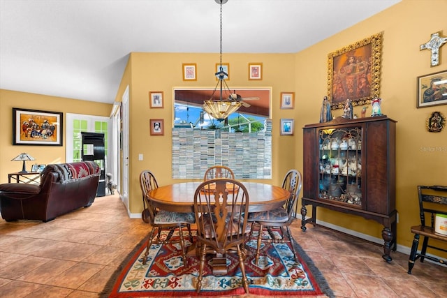 tiled dining area featuring an inviting chandelier