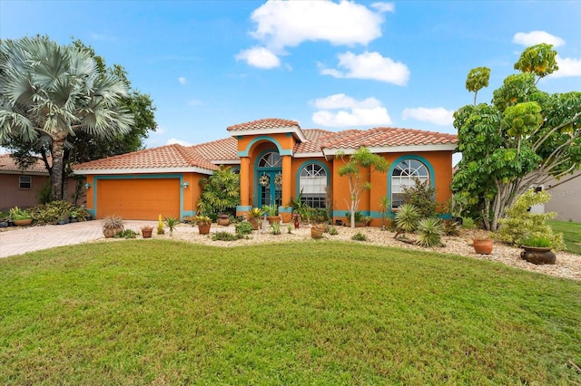 mediterranean / spanish-style house featuring a front yard and a garage