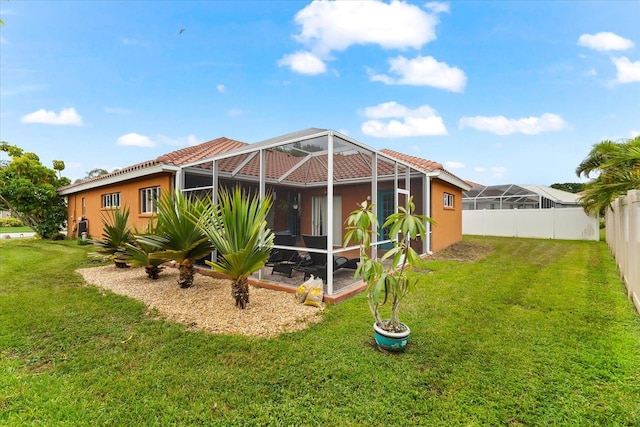 rear view of house featuring a yard and a lanai