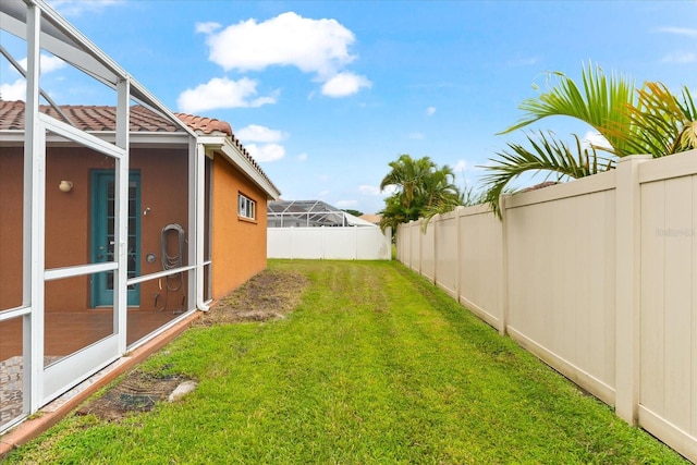 view of yard with a lanai