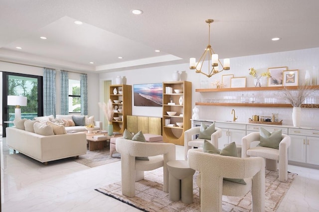 tiled living room featuring a raised ceiling, sink, and an inviting chandelier