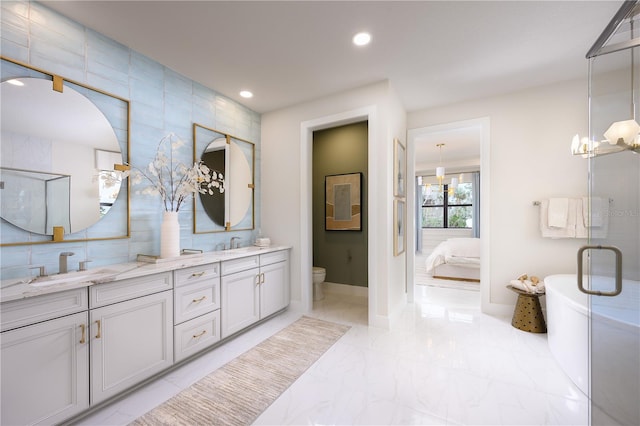 bathroom with tile patterned flooring, double sink vanity, tile walls, toilet, and walk in shower