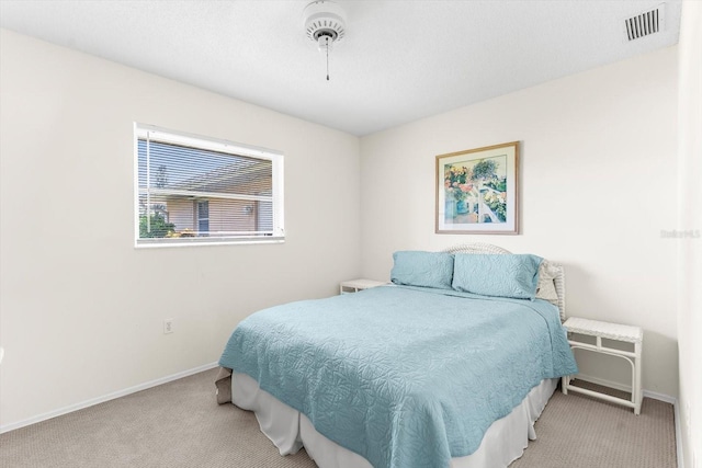 carpeted bedroom with visible vents and baseboards