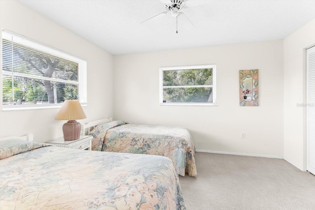 bedroom featuring ceiling fan and carpet