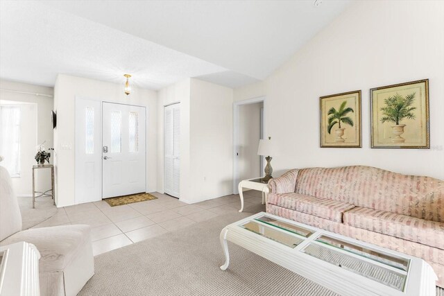 living room featuring light tile patterned floors and vaulted ceiling