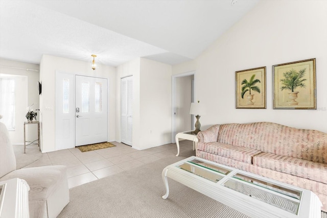 tiled living area featuring vaulted ceiling