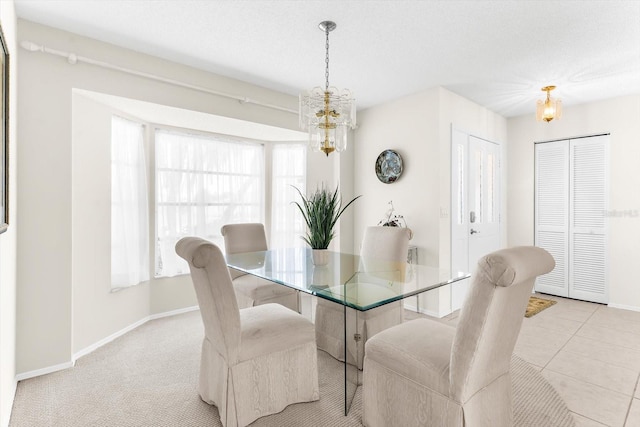 dining area featuring light tile patterned floors, baseboards, light colored carpet, a textured ceiling, and a chandelier