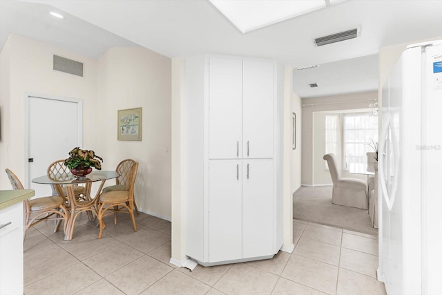 corridor featuring light colored carpet