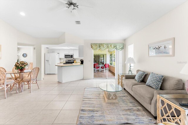 living room with light tile patterned floors and ceiling fan