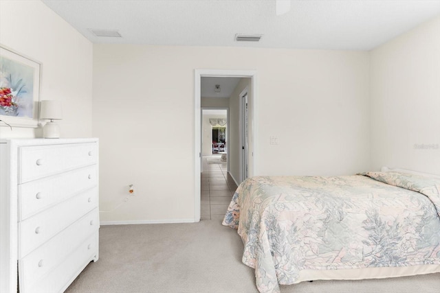 bedroom featuring light carpet, baseboards, and visible vents