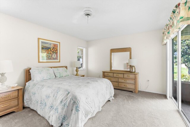 bedroom with light carpet, access to outside, and multiple windows