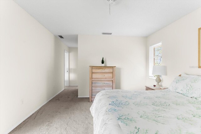 bedroom featuring light colored carpet