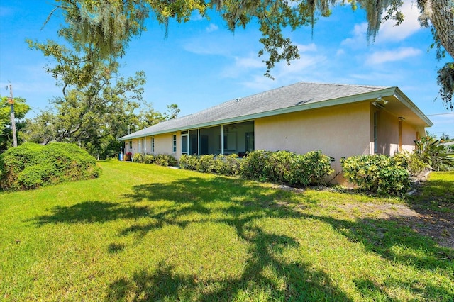 view of side of home with a lawn