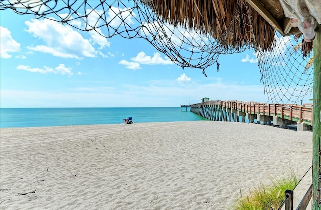 view of water feature featuring a pier and a view of the beach