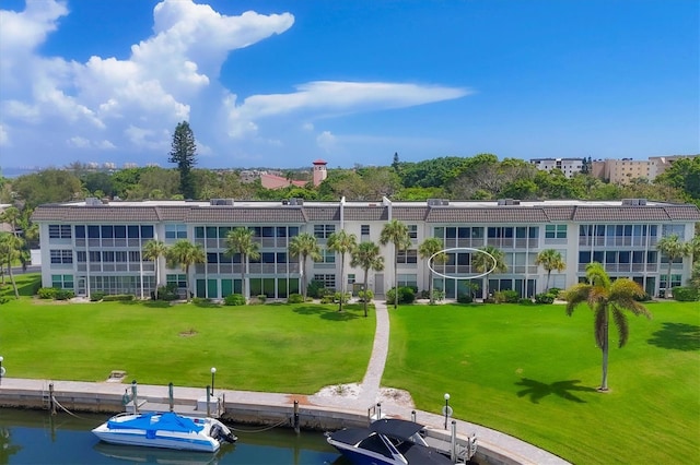 exterior space featuring a water view and a yard