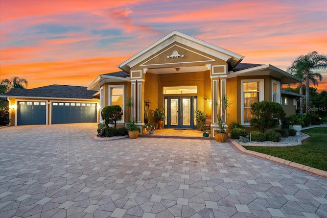 view of front of house with french doors and a garage