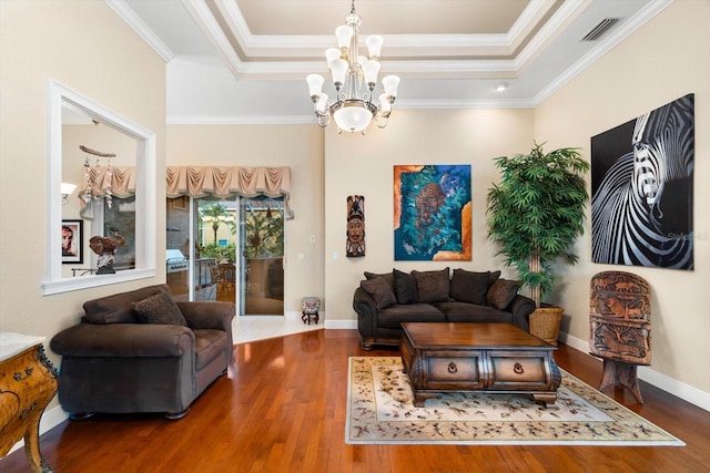 living room featuring crown molding, a tray ceiling, and dark hardwood / wood-style floors