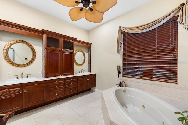 bathroom with ceiling fan, tile patterned flooring, vanity, and a relaxing tiled tub