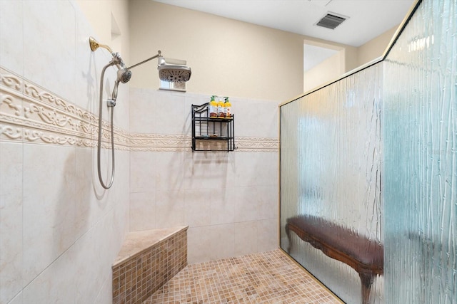 bathroom with tiled shower