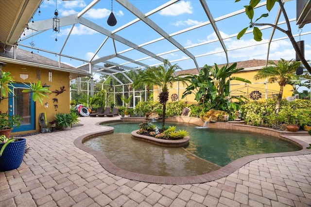 view of swimming pool with a patio, pool water feature, and a lanai