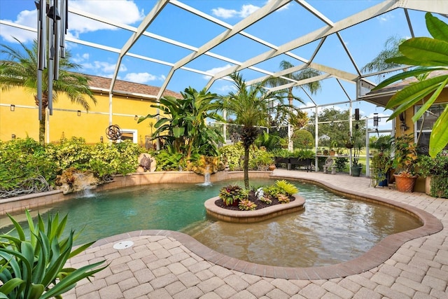 view of pool featuring pool water feature, a lanai, and a patio